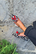 Animal print loafers with red trim