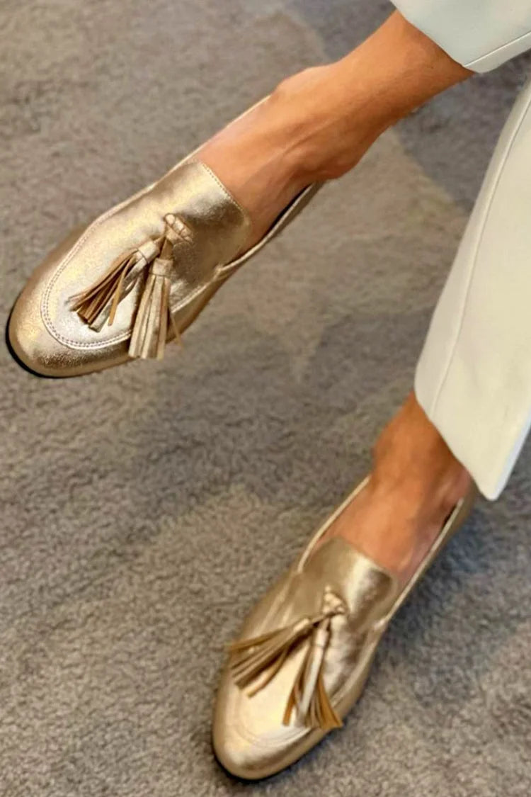 Golden boot with pom-poms