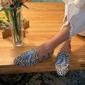 Dotted flat shoes with blue pompoms