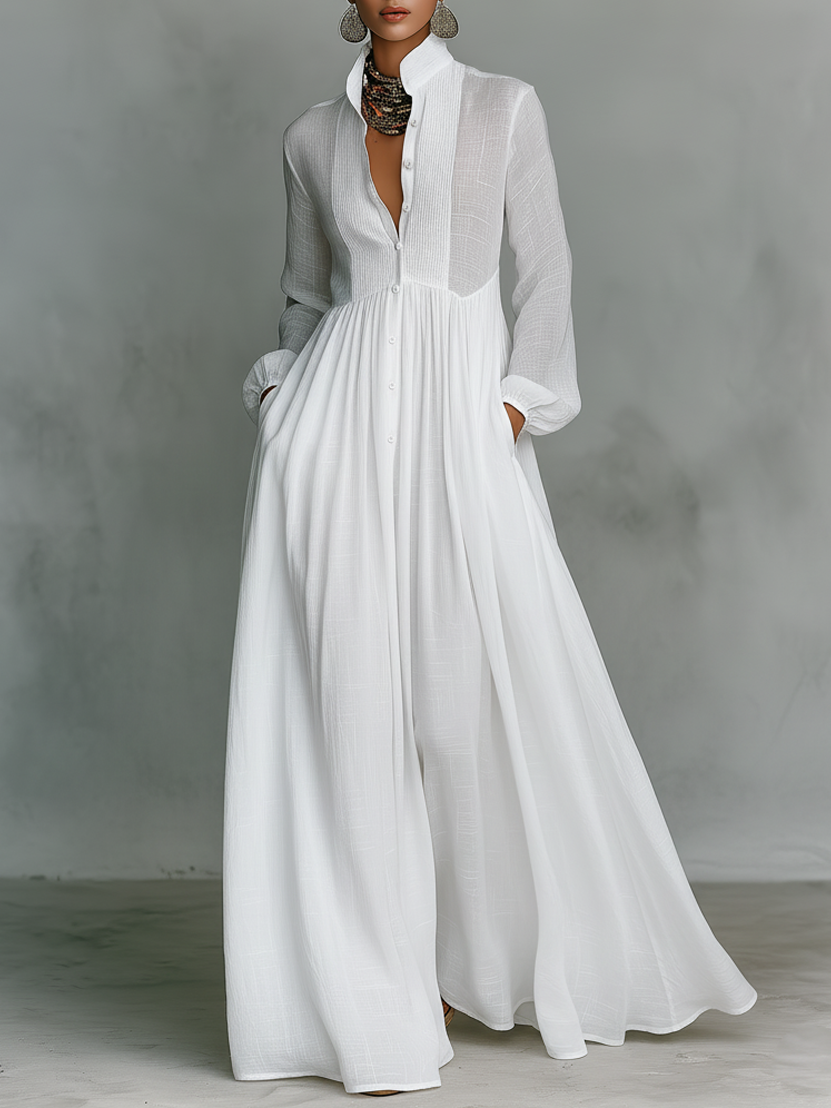 Women's maxi dress in a minimalist style, made of cotton and linen fabric with puzzle pieces, featuring a stand-up collar and long sleeves