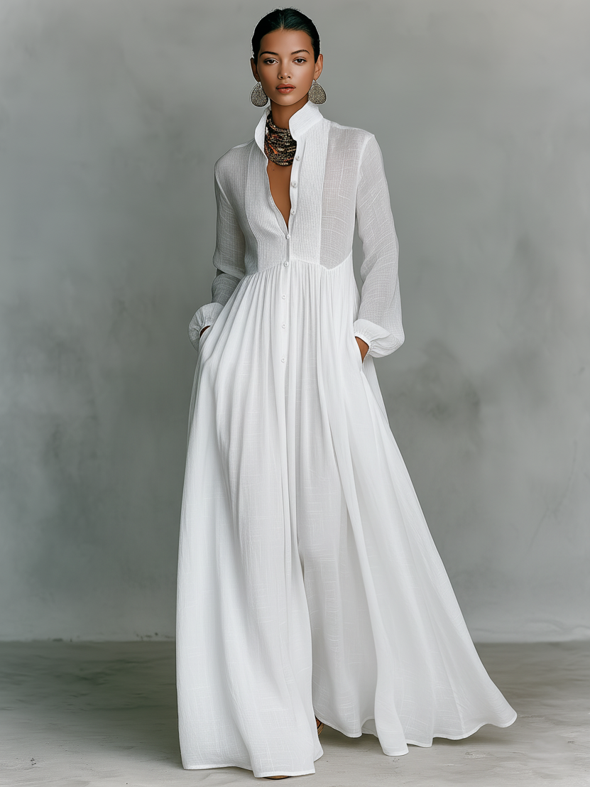 Women's maxi dress in a minimalist style, made of cotton and linen fabric with puzzle pieces, featuring a stand-up collar and long sleeves