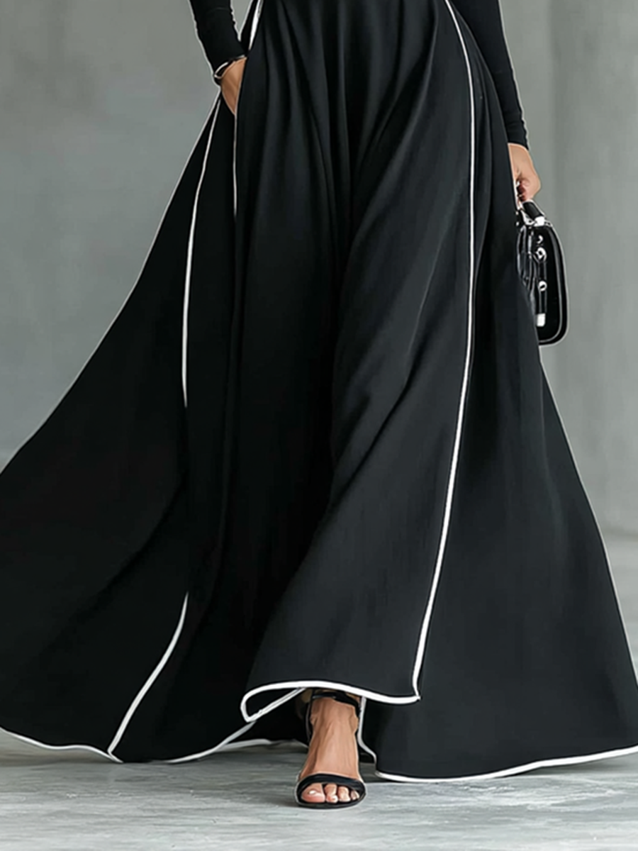 Black maxi dress with white stitching, a high collar, long sleeves, and a narrow waist