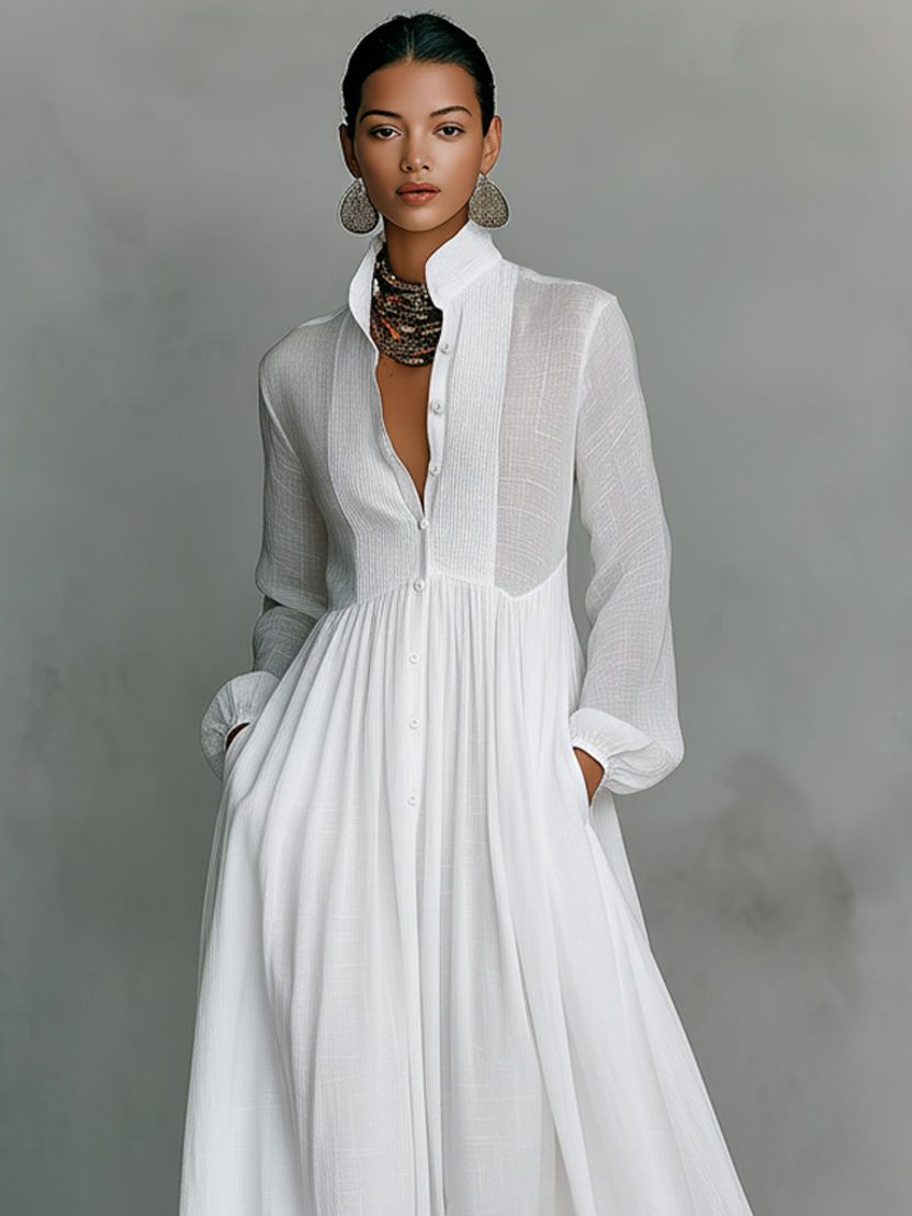 Women's maxi dress in a minimalist style, made of cotton and linen fabric with puzzle pieces, featuring a stand-up collar and long sleeves