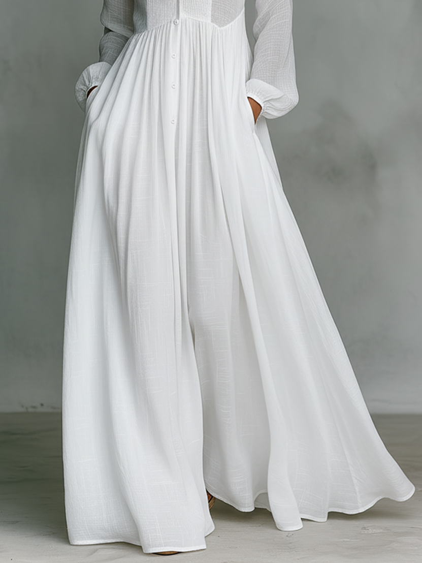 Women's maxi dress in a minimalist style, made of cotton and linen fabric with puzzle pieces, featuring a stand-up collar and long sleeves